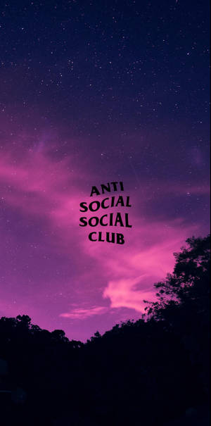 星空夜晚，紫色雲朵，文字 Anti Social Social Club 在樹木剪影上方。 — 反社會社交俱樂部 壁紙