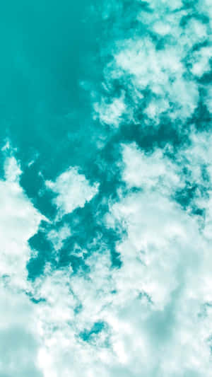 藍綠色天空，蓬鬆的白雲在平靜開闊的大氣中飄移。 — 土耳其藍 壁紙