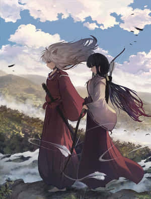 兩位身穿紅袍的動漫戰士，背對背站在俯瞰迷霧山谷的懸崖上。 — Kindle 壁紙