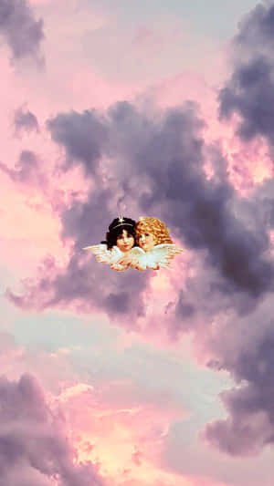 兩個有翼天使漂浮在粉彩粉紅和紫色的天空中。 — 天使 GIF 壁紙