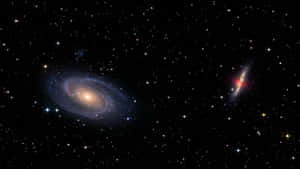 兩個螺旋星系在深邃太空中發光，周圍環繞著無數恆星。 — 宇宙美學 壁紙