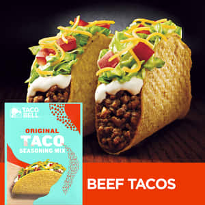 兩個有配料的牛肉玉米餅，旁邊是Taco Bell調味料混合物包裝。 — iPad 第10代 壁紙
