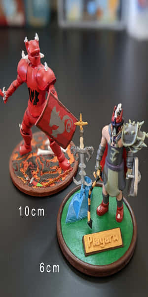 兩個彩繪奇幻微縮模型：一個紅色惡魔戰士和一個裝甲戰士展示中。 — Pixel 3 壁紙