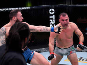 兩名男性MMA拳手在八角籠內進行殘酷的拳擊交鋒。 — 終極格鬥冠軍賽 壁紙