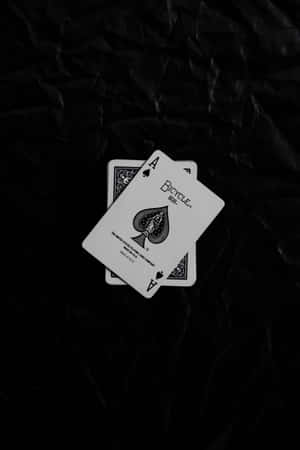 皺巴巴的黑色紙上的兩張Ace of Spades撲克牌。 — 小米平板 9 Pro 壁紙