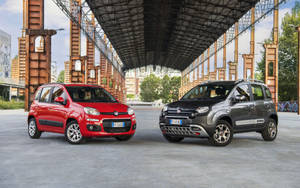 兩輛Fiat Panda汽車停放在一個帶有塗鴉的工業金屬結構下。 — 飛雅特 壁紙