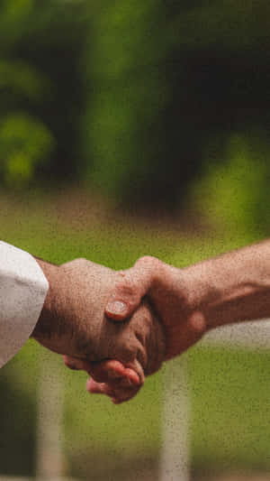 兩隻手在戶外緊緊握實。 — 手牽手 壁紙