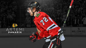 冰球運動員 Artemi Panarin 身穿紅色黑鷹隊球衣在冰上慶祝。 — 運動 壁紙
