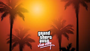 Grand Theft Auto Vice City 標誌在日落和棕櫚樹剪影前。 — 碧蓝之海 壁紙