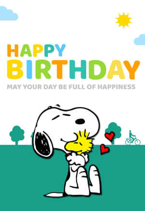 史努比和胡士托在陽光明媚的場景中擁抱，帶有「Happy Birthday」文字和心形。 — 生日快樂蛋糕 壁紙