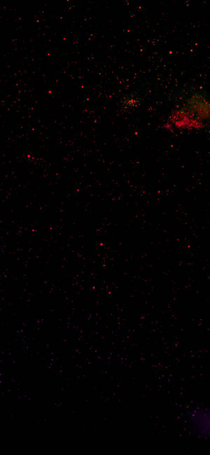 充滿紅色星星和發光星雲的黑暗太空。 — 紅色美學 iPhone 壁紙