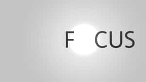 單詞 focus 中的字母 O 在灰色漸變上呈現為發光的白色圓圈。 — 手牽手 壁紙