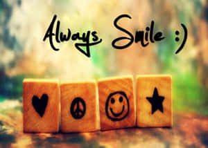 四個帶有符號和文字 'Always Smile :)' 的木塊 — 笑臉 壁紙