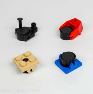 白色背景上四個帶黑色輪轂的LEGO Technic組件 — 樂高旋風忍者 壁紙