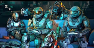 Halo士兵在沙發上閒逛玩電子遊戲，一人睡著，另一人驚訝。 — 最後一戰：無限 4K 壁紙