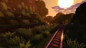 Minecraft火車軌道穿過夕陽下的草坡。 — 日落 壁紙