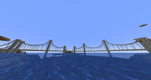 在晴朗的天空下，一條Minecraft吊橋橫跨藍色的水面。 — 塔橋 壁紙