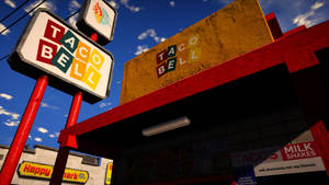 Taco Bell 速食餐廳，帶有紅色招牌和藍色天空背景。 — 塔可 壁紙