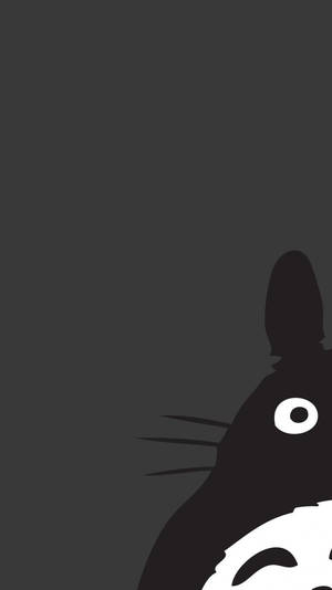 龍貓的剪影從深灰色背景的右下角探出頭來。 — Marshmello iPhone 壁紙
