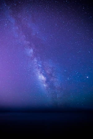 銀河系在繁星點點的夜空中散發出紫色和藍色光芒。 — 星星 壁紙