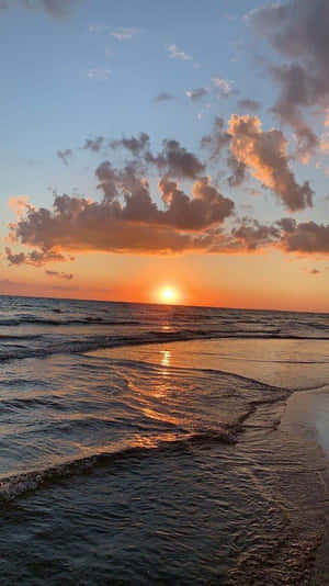 夕陽下的海洋，有海浪和雲朵 — 海灘 壁紙