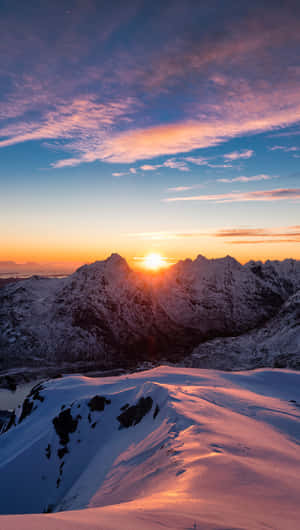 積雪的山峰沐浴在金色的夕陽光中，上方有色彩繽紛的雲彩。 — 日落 壁紙