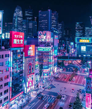 充滿活力的東京夜景，閃爍的霓虹燈招牌和繁忙的街道。 — 城市 壁紙