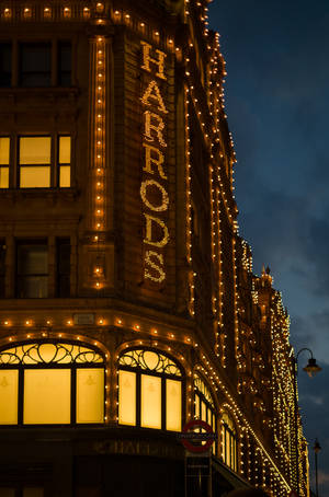 Harrods 百貨公司在夜晚以金色燈光和經典建築照明。 — Huawei MatePad Pro 12 (2026) 壁紙