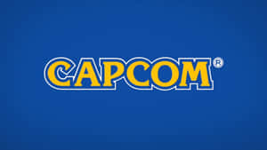 藍色背景上黃色帶白色輪廓的 Capcom 標誌 — 卡普空 壁紙