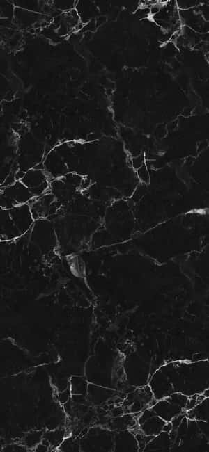 帶有白色紋理的黑色大理石表面，適合優雅的室內設計。 — Galaxy A57 壁紙