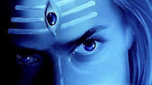 在深藍色燈光下，擁有藍色眼睛和額頭上畫有第三隻眼符號的女人。 — 靈性美學 壁紙