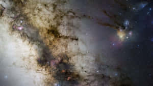 宇宙星雲，帶有旋轉的塵雲和發光氣體，背景為星場。 — 星星 壁紙