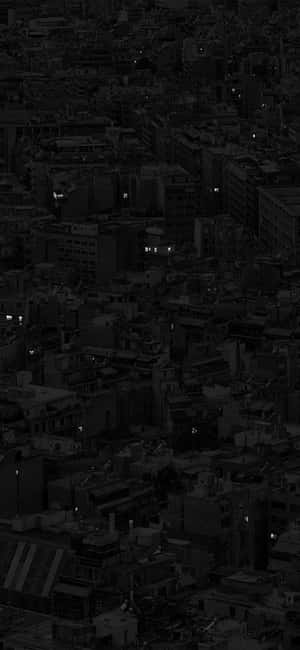 密集城市的夜間鳥瞰圖，黑暗中帶有發光的窗戶。 — 暮光 壁紙