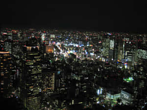 夜間城市景觀，摩天大樓和街道燈火通明。 — 城市燈光 壁紙