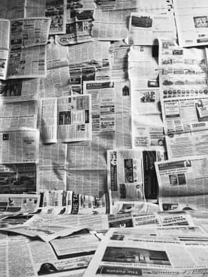 牆壁覆蓋著重疊的報紙剪報，帶有標題和廣告。 — Old Paper 壁紙