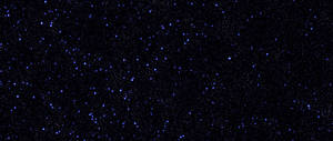 黑色背景上充滿發光藍色星星的星空夜空。 — 2560x1080 壁紙