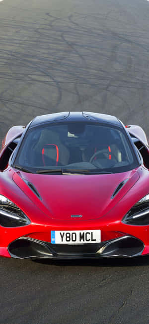 賽道上帶有輪胎痕的紅色McLaren跑車 — Redmi Note 13 Pro 壁紙