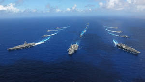 航空母艦和驅逐艦編隊航行在開闊的海洋上。