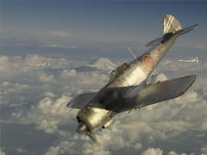三架復古日本戰鬥機在雲層上飛行，背景是富士山。 — 慶祝 壁紙