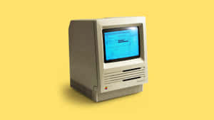 米色復古 Macintosh SE 電腦，藍色螢幕，黃色背景。 — 螢幕 壁紙