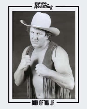 摔角手 Bob Orton Jr. 戴著牛仔帽和流蘇背心，握緊拳頭擺姿勢。 — 運動 壁紙