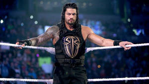 摔角選手 Roman Reigns 在場中雙臂張開面向觀眾。 — 羅曼·雷恩斯 壁紙