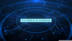 數位電路圖案，文字 'THE WORLD IS CHANGING' 在藍色中發光。 — 名言 壁紙