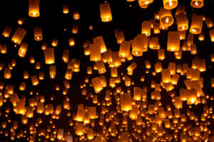 數百盞發光的天燈升入黑暗的夜空。 — 暮光 壁紙