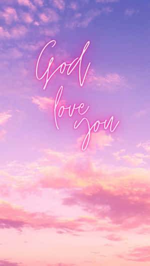 霓虹字體 God love you 映襯著粉彩日落天空。 — 神 壁紙