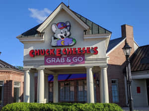 Chuck E Cheese's餐廳，卡通老鼠吉祥物和即取即走標誌。 — 查克芝士 壁紙