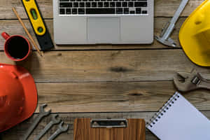 配備工具、筆記型電腦、咖啡和安全帽的工作檯，適用於建築或工程工作。 — 最佳桌面 壁紙
