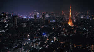 夜晚的東京城市景觀，東京鐵塔亮起燈光。 — 筆電 壁紙