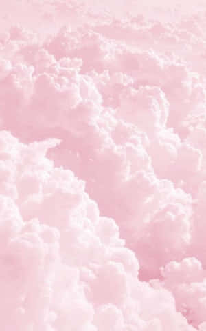 粉紅蓬鬆雲朵漂浮在柔和的粉彩天空 — 雲朵 GIF 壁紙