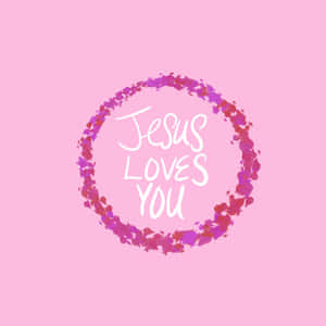 粉紅色背景上，彩色水彩花環內有白色草書「Jesus Loves You」文字 — 神的話語 壁紙